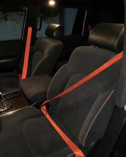 Premium custom orange seatbelts installed in a luxury car interior by Roh Accessoires Morocco